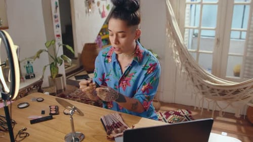 Woman Applying Makeup at a Ring Light