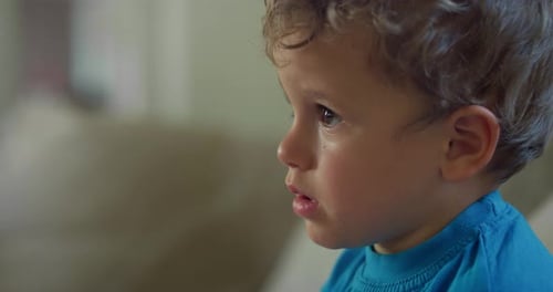 Close Up Portrait of a Little Adorable Child Focused on a TV Screen. Macro Shot Happy I