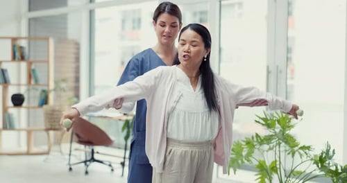 Woman Doing Physical Therapy with Assistant