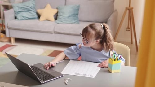 Eleven Year Old Girl Using Laptop during Maths Homework