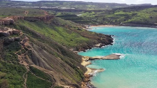 Aerial view of green cliffs and turquoise water, Malta.