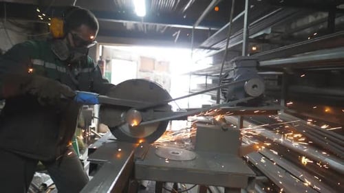 Man with Circular Saw Sawing Steel in Garage Worker in Safety Protection Wear Use Saw Cutting