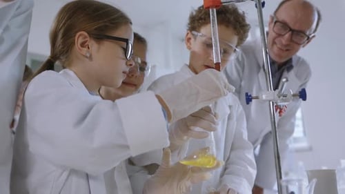 Children Conduct Science Experiment in Lab with Supervisor