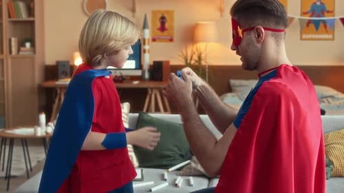 Father and Child in Superhero Costumes Together