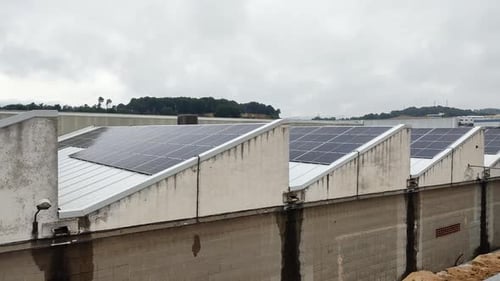 Energy Innovation: Solar Panels on Factory Roof.