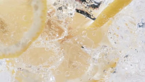 Lemon Slices and Ice Cubes in Soda Water