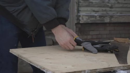 A Worker Putting On The Industrial Gloves Before Starting The Work. -medium shot
