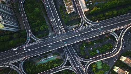Aerial Top Down View of a Busy Junction Reveals a Multitude of Vehicles Traveling on Various