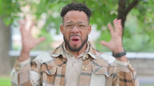 Angry Man Shouting, Raising Hands in Frustration