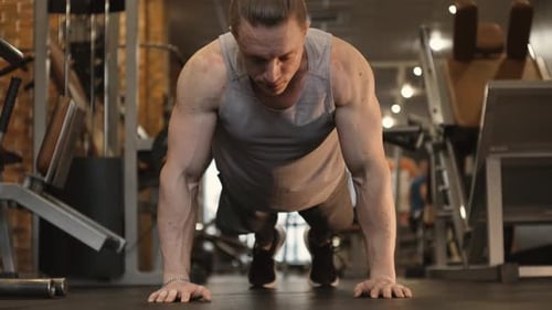 Strong Athlete Doing Push Up Exercise in Gym