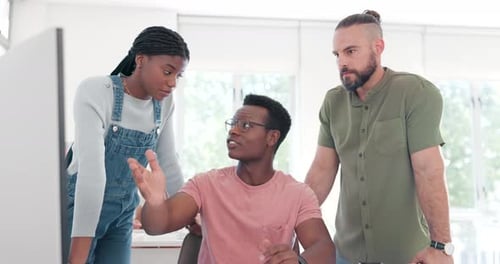 Team Collaboration Around Computer in Modern Office