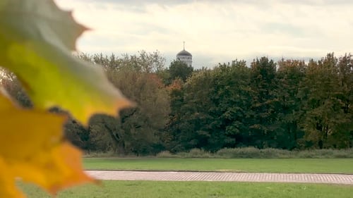 Park scene with building surrounded by autumn trees