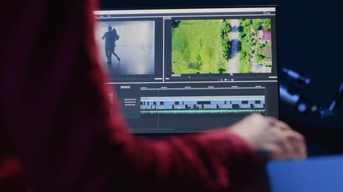 Video Editor Analyzing Film Montage Before Editing Color Grading and Lighting in Creative Office
