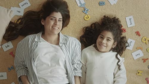 Mother and Daughter Learning Together on Carpet