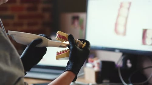 NEW YORK February 19 2020 Female Dental Scientist in Laboratory Makes New Artificial Teeth Using