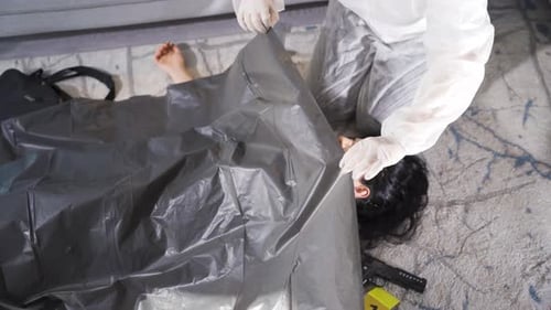 Crime Scene Investigation Covering Body with Plastic Sheet