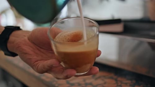 Barista Hands Preparing Cappuccino in Cafeteria with Espresso Machine Close Up
