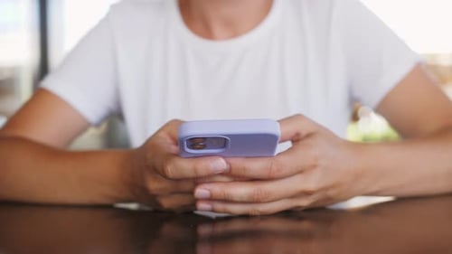 Close Up Person Holding Smartphone Scrolling Personal Page in Social Network Looking at Photos