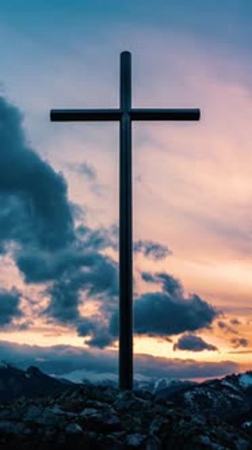 Christian Cross Silhouette Against a Sunset Mountain Landscape