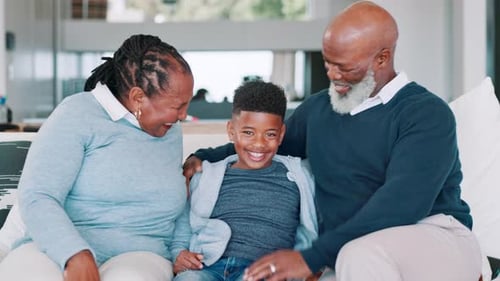 Family Smiling Together Indoors on a White Sofa