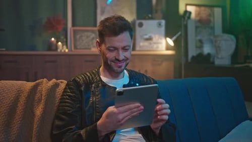 Man on Couch Using Tablet at Home