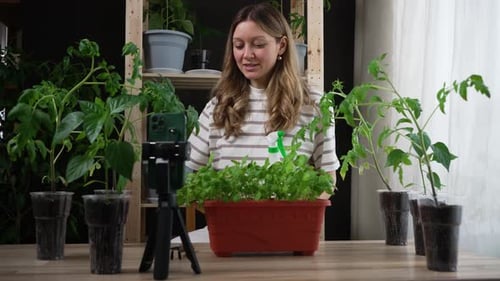 Woman Records Gardening Video with Smartphone Indoors