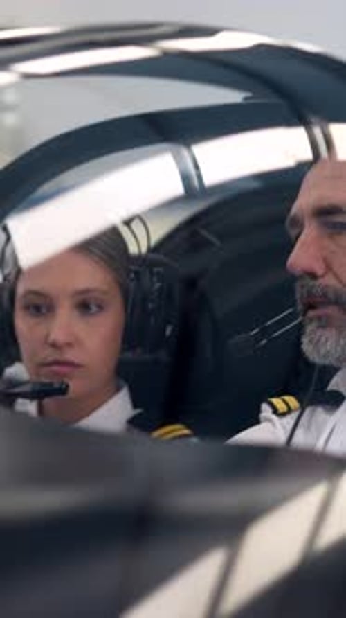 Experienced Male Instructor Teaching Female Aviation Student to Fly an Aircraft