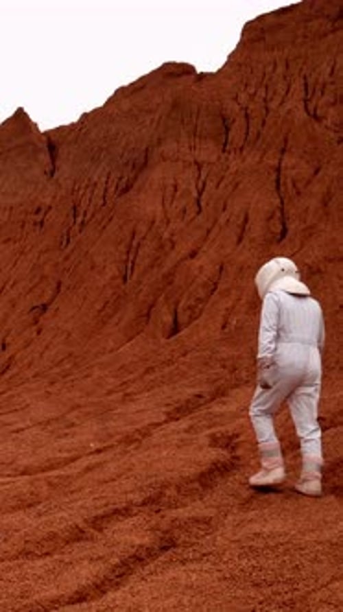 Vertical of Astronaut Exploring Mars Surface Tracking Drone Shot