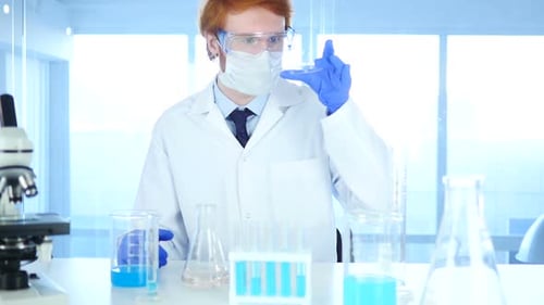 Medical Scientist Studying Reaction in Watch Glass in Laboratory