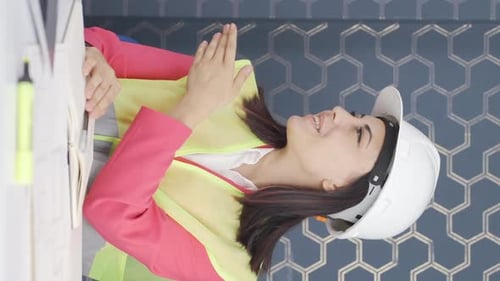 Vertical video of Woman engineer presents project.