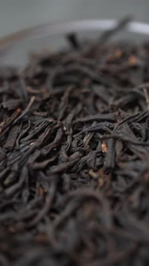 A Close Up View of Beautifully Dried Black Tea Leaves Displayed Neatly in an Elegant Bowl Media