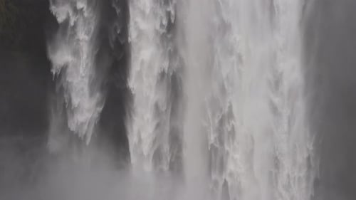 Majestic Waterfall Flowing Down Rocky Cliffs