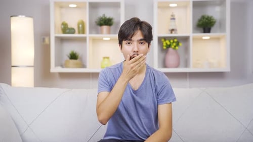 Young Man Gesturing and Talking on Couch