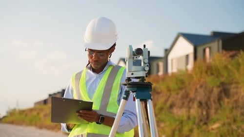 Construction Engineer Surveys Land with Theodolite Tool