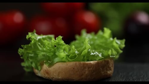 Preparing Lettuce on Burger Bun, Close Up