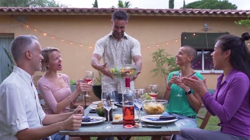 Friends Gather for Sunny Outdoor Wine and Salad