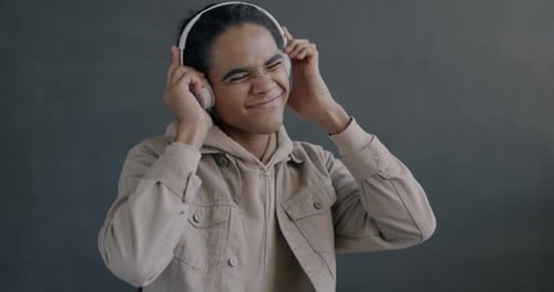 Young Man Enjoys Music with Headphones