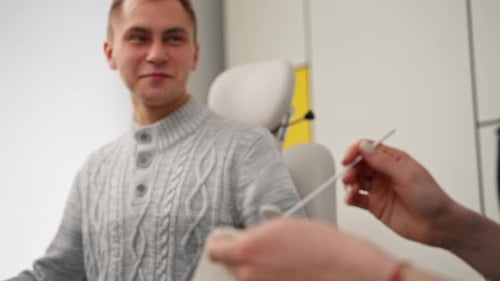 Closeup in Clinic Young Doctor Ear Throat Nose Ready to Examine the Patient