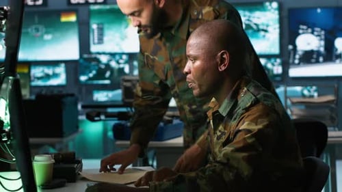 Soldiers Collaborating on Computer Technology in Futuristic Workplace