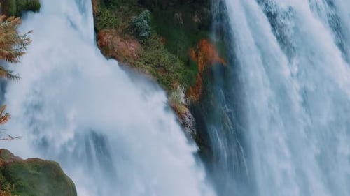 White Foamy Waterfall Flows From the Cliff