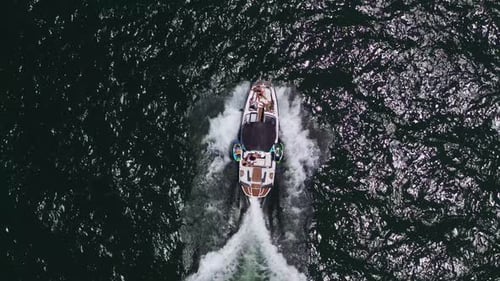 Speed boat with people roaring across the Sea at high speed