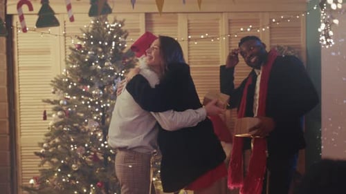 Friends Giving Christmas Gifts at a Holiday Party