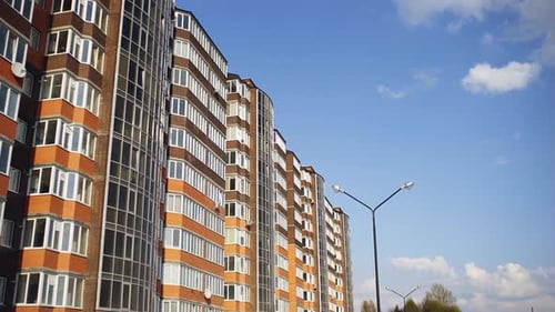 A Newly Built Multistorey Residential Building on a Background of Blue Summer Sky