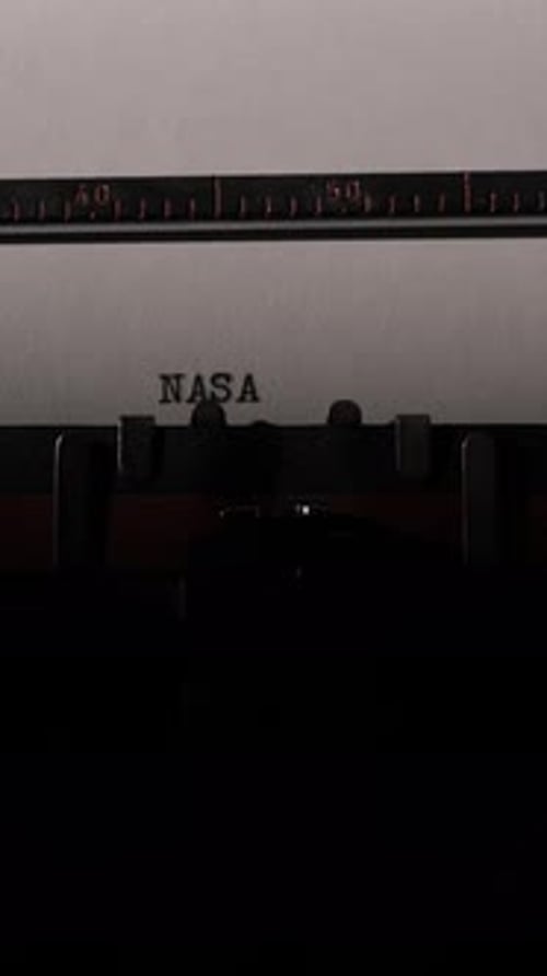 Typewriter Typing NASA on White Paper Close Up