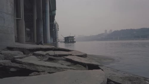 A man fishing by the river