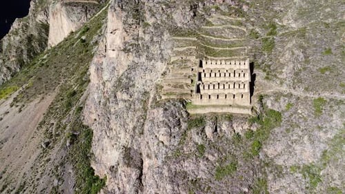 Panoramic aerial overview of historic town site of Ollantaytambo cut out of hillside in Peru
