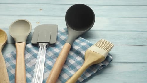 Wooden Cutlery Fork and Spoon on a Chopping Board on Table