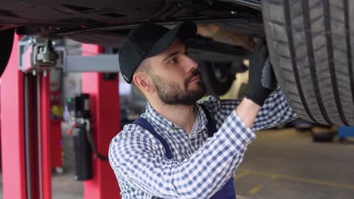 Mechanic Working on Car in Auto Repair Shop