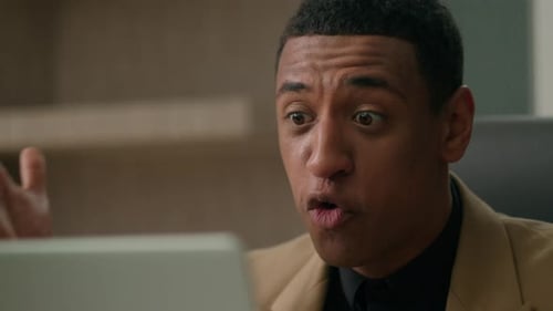 Man Reacts While Looking at Computer in Office