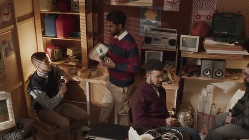 Team of Tech Lovers Having Beer Party at Retro Garage